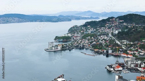 coastal town nestled along winding fjord white colorful buildings green covered hills distant misty mountains rise above water's edge norway bergen city center port green-covered 