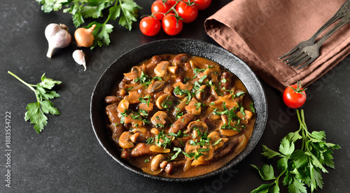 Beef stroganoff with mushrooms in frying pan