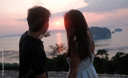Romantic Couple Watching Sunset Over Tropical Sea and Islands at khaothong , Krabi