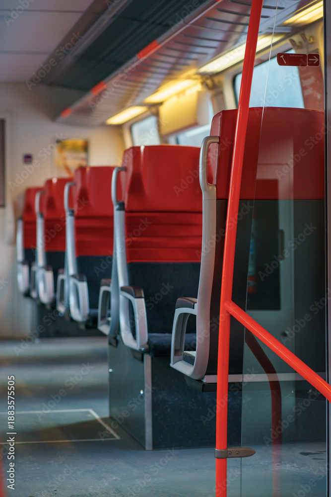 Fototapeta premium Stylish interior view of a modern passenger train with red seats and soft focus, conveying calm, efficiency, and modern public transportation