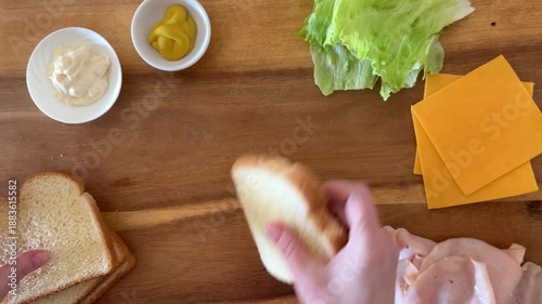 Making a Turkey Sandwich: Adding White Bread to a Wooden Cutting Board