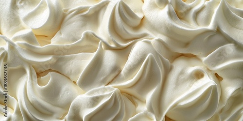 Decorative whipped cream icing patterned like a wave.