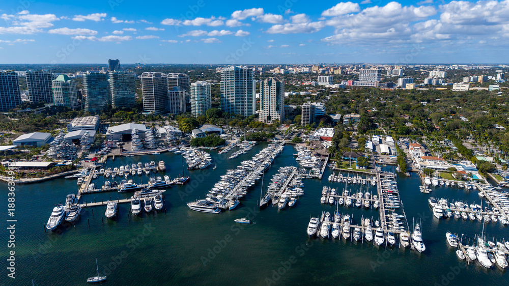 Fototapeta premium Aerial view of boat marina with city buildings in the background