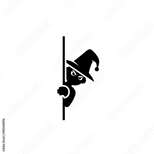 Black silhouette of a witch peeking from behind a pole.