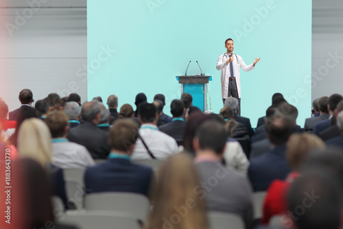 Doctor giving a speech on stage at a medical conference i