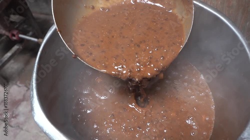 Closeup shot of cooking dal makhni in big utensil.
cooking in Bulk for many people.