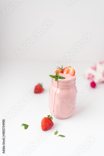 Strawberry smoothies in glasses on white background