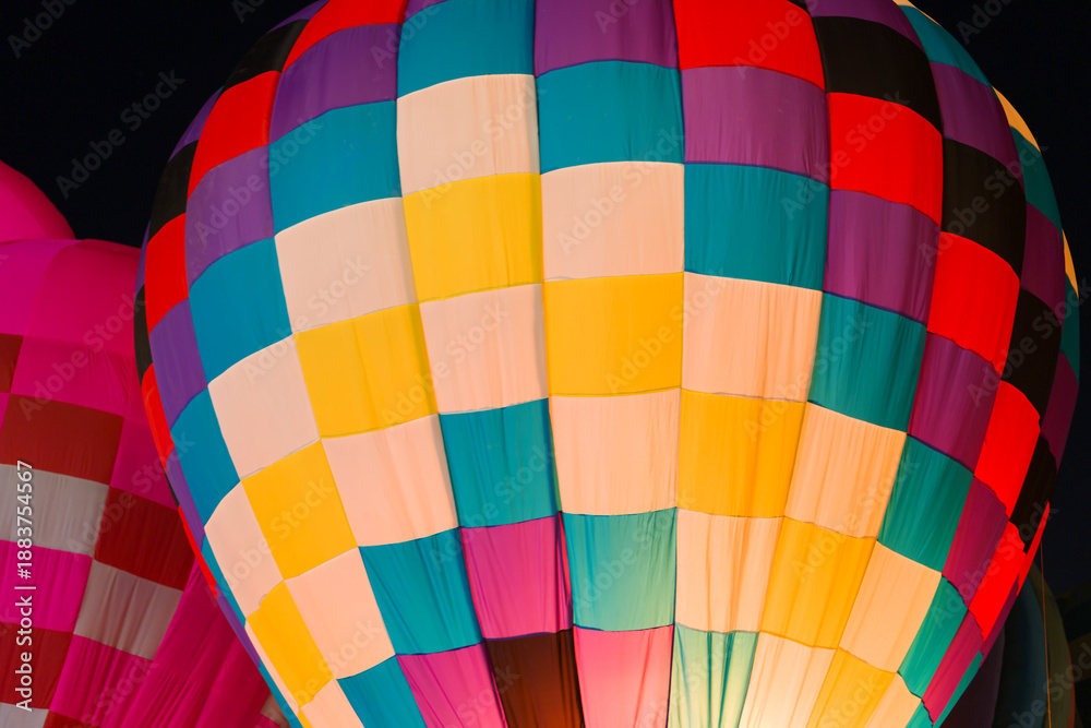 Fototapeta premium colorful hot air balloons glowing against dark night sky
