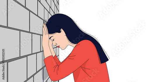 Distressed woman leaning her head against a brick wall representing feelings of exhaustion, frustration, and mental fatigue.