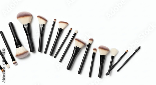A professional set of makeup brushes and artist tools featuring wood handles and metal steel ferrules arranged as a close up group for creative painting and design work