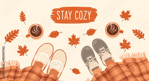 Cozy autumn scene with feet in slippers and shoes, warm cups of coffee, and falling orange maple leaves on the ground.