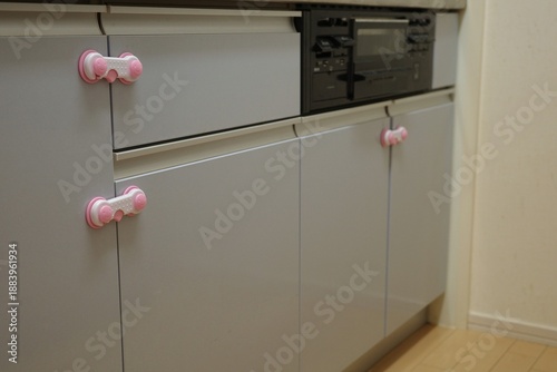 Child proof safety locks installed on kitchen cabinet doors and drawers.