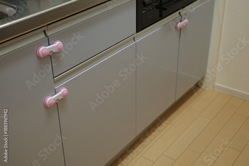 Child proof safety locks installed on kitchen cabinet doors and drawers.