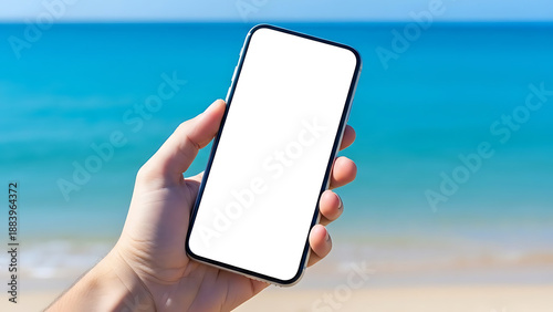 Hand Holding Smartphone with Blank Screen by Sea Beach