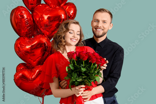 Young couple with roses and...