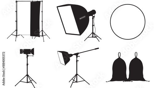Photography studio equipment arranged for a professional photoshoot with lighting, camera, and backdrops