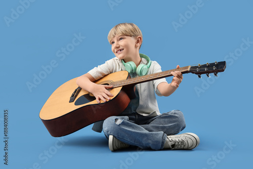 Little boy playing guitar o...