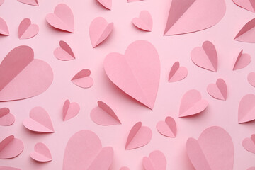 Composition with paper hearts on pink background. Valentine's Day celebration