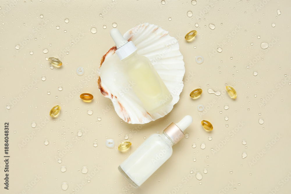 Obraz premium Bottles of cosmetic products and pills with collagen on beige background with water drops