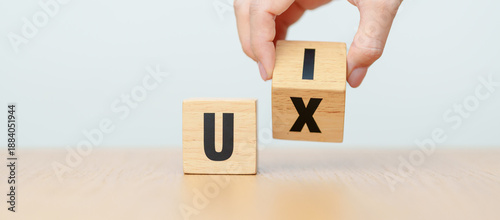 Foto hand change wooden block from UI to UX