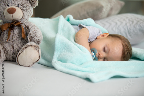 Принти на полотні baby asleep with a pacifier and a teddy-bear