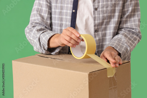 Young woman taping up cardb...