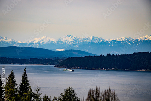 Obraz na płótnie Washington State Ferry underway in Elliott Bay with mountains behind and trees i