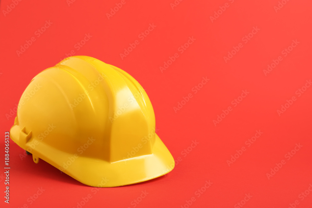 Fototapeta premium Yellow hardhat on red background