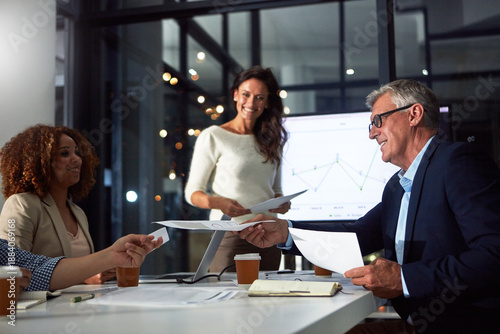 Tableau sur toile People, presentation and paperwork in office at night with finance report, data analysis and profit