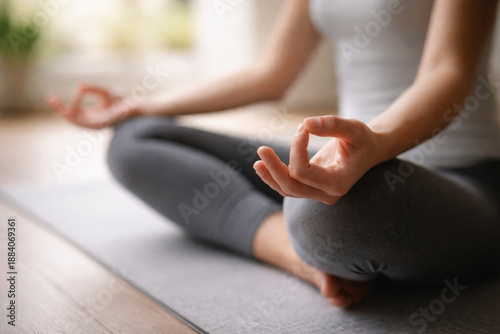 Canvastavla Woman meditating in a peaceful lotus pose on a yoga mat, practicing mindfulness and inner calm