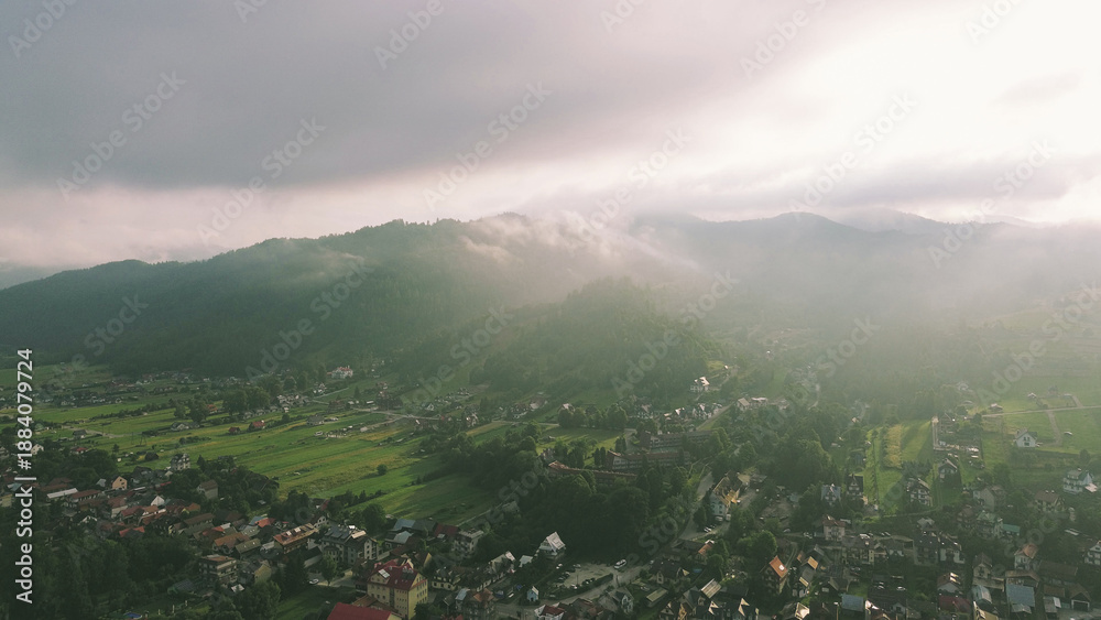 Fototapeta premium Serene rural valley with fog and sunrise glow