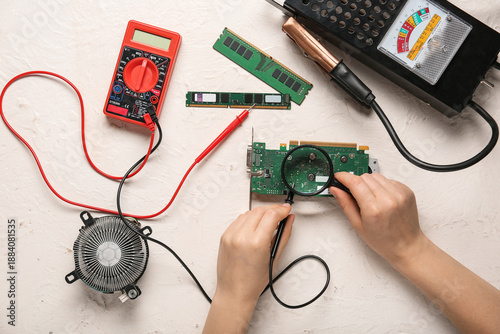 Young woman with multimeter...