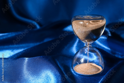 Crystal hourglass on blue b...
