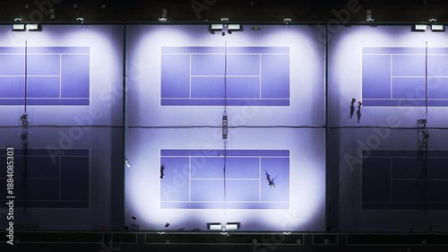 Aerial view of modern tennis court at night