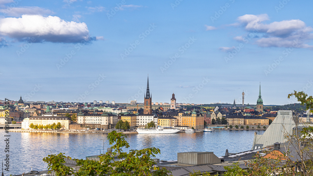 Fototapeta premium Stockholm, Sweden skyline by the water with historic towers and green hills