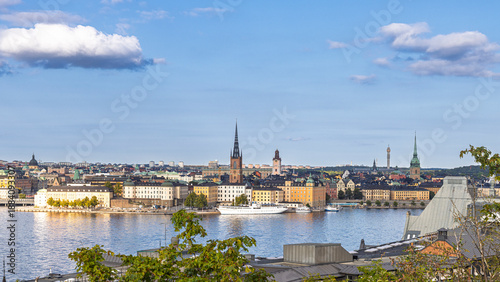 Stockholm, Sweden skyline by the water with historic towers and green hills
