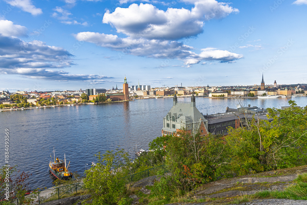 Obraz premium Stockholm, Sweden skyline by the water with historic towers and green hills
