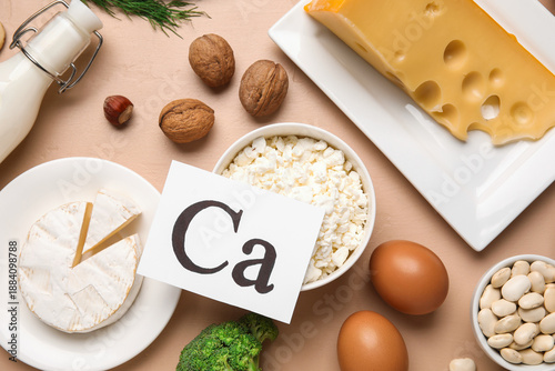 Wallpaper Mural Paper with symbol of calcium and healthy products on beige background Torontodigital.ca