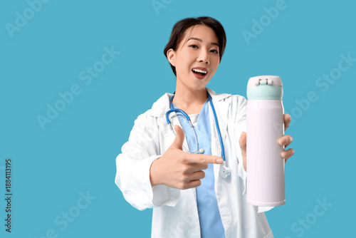 Female Asian doctor pointin...