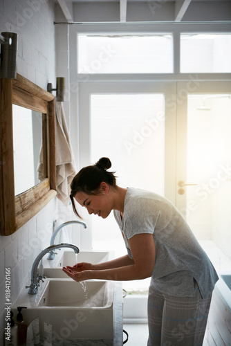Fotografia Cleaning, washing face and skincare with woman in bathroom for self care, morning and facial maintenance