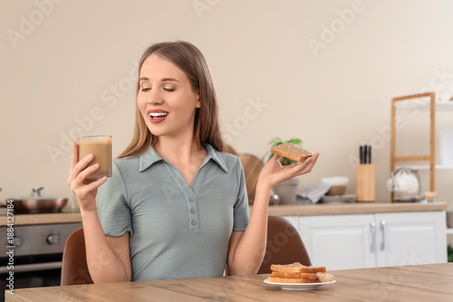 Young woman holding toast a...