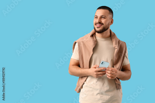Happy young man with mobile...
