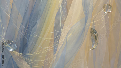 Translucent blue and cream fabrics billow, interwoven with gossamer threads. Crystal orbs, like frozen teardrops, dangle ethereally, catching light in a shimmering display.