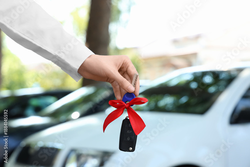 Female hand with gift keys ...
