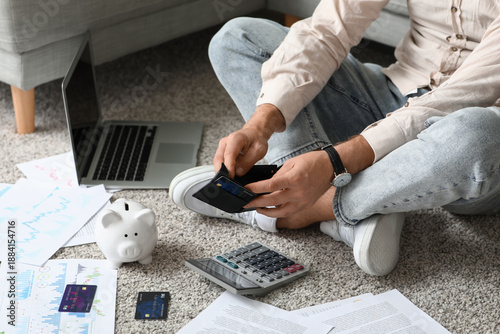 Young man in debt with empt...
