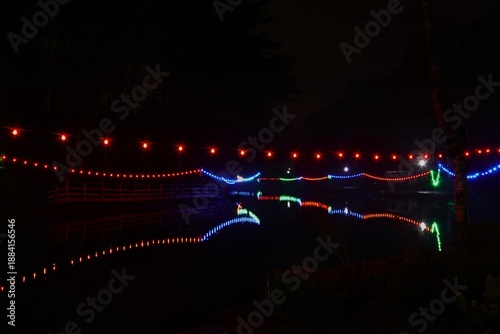 Lights across a pond at night with reflections