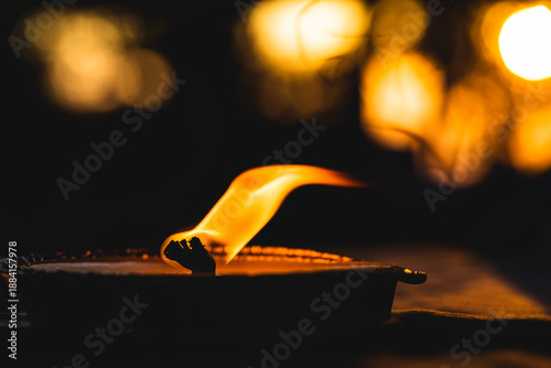 Quadro em tela sagoma e fiamma di candela su un tavolo, in controluce, in un ambiente scuro, co