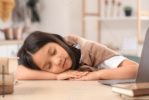Tired little Asian girl wit...