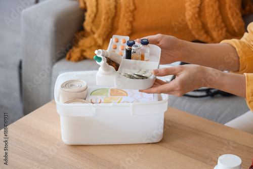 Woman with first aid kit an...