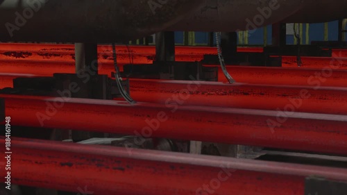 Glowing hot steel billets moving through foundry production line